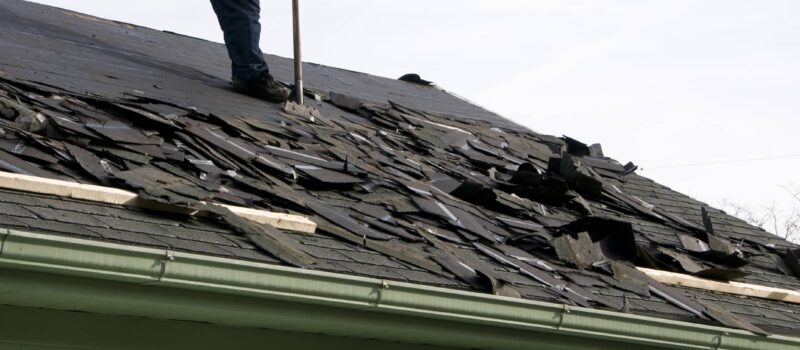 This is an image of a contractor preparing to replace a damaged roof.